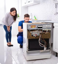 Technician repairing fridge