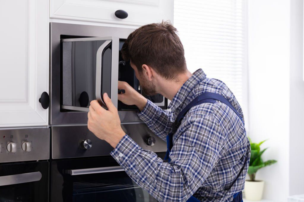 Technician repairing fridge